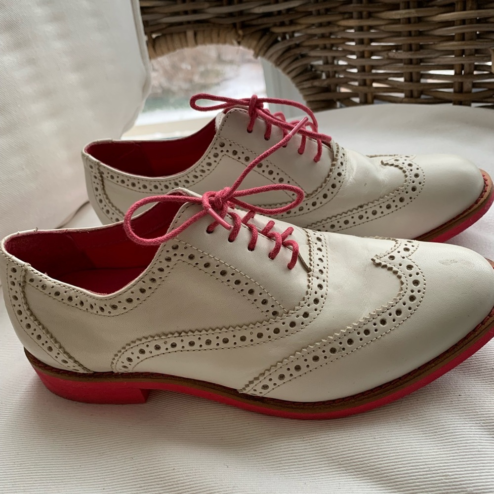 White leather spectators with bright pink laces and crepe sole. Size 5-1/2.